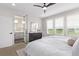 Bright bedroom with an ensuite bathroom behind a glass door and windows with shutters at 14998 Cast Pebble Cir, Parker, CO 80134
