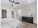 Bright bedroom with ensuite bathroom, walk-in closet, and three shuttered windows at 14998 Cast Pebble Cir, Parker, CO 80134
