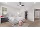 Bright bedroom featuring two pink stools and a black nightstand next to the bed at 14998 Cast Pebble Cir, Parker, CO 80134