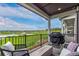 Relaxing covered deck featuring views of the community park, lush greenery, and grilling area at 14998 Cast Pebble Cir, Parker, CO 80134
