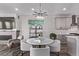 Dining area featuring a marble table and designer lighting, adjacent to the living room at 14998 Cast Pebble Cir, Parker, CO 80134