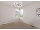 Empty room with two shuttered windows, a modern ceiling light, and neutral carpet at 14998 Cast Pebble Cir, Parker, CO 80134