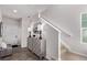 Elegant entryway with hardwood flooring, a modern console table with lamps, and staircase to upper floor at 14998 Cast Pebble Cir, Parker, CO 80134