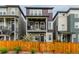 Beautiful two-story townhome boasts a covered balcony, stone accents, and gated front yard at 14998 Cast Pebble Cir, Parker, CO 80134