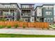 Inviting two-story townhome with a charming porch, stone accents, and well-manicured front yard at 14998 Cast Pebble Cir, Parker, CO 80134