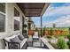 Relaxing covered front porch with outdoor seating and a view of the landscaped yard at 14998 Cast Pebble Cir, Parker, CO 80134