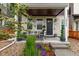 Inviting front porch with comfortable seating and lush landscaping and neutral exterior at 14998 Cast Pebble Cir, Parker, CO 80134