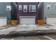 Street view of townhome garage with a modern facade and convenient driveway at 14998 Cast Pebble Cir, Parker, CO 80134