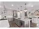 Modern kitchen featuring a large island, stainless steel appliances, and elegant pendant lighting at 14998 Cast Pebble Cir, Parker, CO 80134