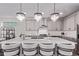 Elegant kitchen with modern pendant lighting, stainless appliances, and an expansive island at 14998 Cast Pebble Cir, Parker, CO 80134