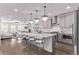 Spacious open-concept kitchen with a large island and seamless flow to the living room and dining area at 14998 Cast Pebble Cir, Parker, CO 80134