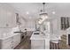 Modern kitchen featuring a large island, stainless steel appliances, and elegant pendant lighting at 14998 Cast Pebble Cir, Parker, CO 80134