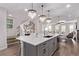 Open-concept kitchen with a large island, pendant lighting, and seamless flow to the living spaces at 14998 Cast Pebble Cir, Parker, CO 80134