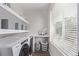 Well-lit laundry room with washer and dryer hookups and shelving with window at 14998 Cast Pebble Cir, Parker, CO 80134