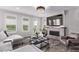 Bright living room with large windows, fireplace, and comfortable seating arrangements at 14998 Cast Pebble Cir, Parker, CO 80134