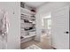Walk-in closet featuring white shelving and a view into the bedroom at 14998 Cast Pebble Cir, Parker, CO 80134