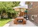 Charming backyard with patio and wooden picnic table with sun umbrella, perfect for outdoor entertaining at 1767 S Sherman St, Denver, CO 80210