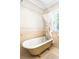 Charming bathroom featuring a clawfoot tub with vintage fixtures and natural light at 1767 S Sherman St, Denver, CO 80210