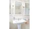 Classic bathroom with pedestal sink, decorative tile, and sconces adding a touch of elegance at 1767 S Sherman St, Denver, CO 80210
