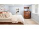 Cozy bedroom with a wood frame bed, comfortable bedding, and a rustic dresser at 1767 S Sherman St, Denver, CO 80210