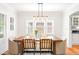 Elegant dining room with a modern light fixture, large window and hardwood floors at 1767 S Sherman St, Denver, CO 80210