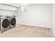 Functional laundry room with modern washer and dryer, ample space, and storage options at 1767 S Sherman St, Denver, CO 80210