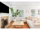 Comfortable living room featuring a fireplace, hardwood floors, and a neutral color scheme at 1767 S Sherman St, Denver, CO 80210