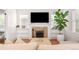 Cozy living room with a fireplace, built-in shelves, and a large picture window at 1767 S Sherman St, Denver, CO 80210