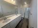 Bathroom with double sinks, modern vanity, and glass enclosed shower at 22813 E Tufts Ave # B, Aurora, CO 80015