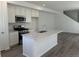 Modern kitchen featuring white cabinets, stainless steel appliances, and quartz countertops at 22813 E Tufts Ave # B, Aurora, CO 80015
