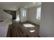 Bright living room with wood floors and natural light from windows and sliding glass door at 22813 E Tufts Ave # B, Aurora, CO 80015