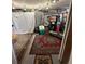 Cluttered basement room with exposed ceiling, vintage rugs, and various stored items, some covered at 1265 Yates St, Denver, CO 80204