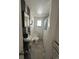 Compact bathroom with an unusual sink, marbled floor, shower, and black & white tile accents at 1265 Yates St, Denver, CO 80204