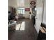 Comfortable living area with natural light, carpeted floors, and a view into the kitchen at 1265 Yates St, Denver, CO 80204