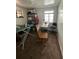 Untidy storage space with an ironing board, sewing machine, and an array of plastic storage containers at 1265 Yates St, Denver, CO 80204