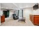 Basement with neutral carpet, a TV, and a cabinet at 6774 St Vrain Ranch Blvd, Firestone, CO 80504