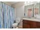 Bright bathroom featuring a single sink vanity and shower at 6774 St Vrain Ranch Blvd, Firestone, CO 80504