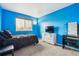 Bedroom with a light blue wall, a large window, and a dark grey bed at 6774 St Vrain Ranch Blvd, Firestone, CO 80504