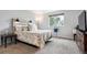 Bright bedroom with a queen bed, gray carpet, and plenty of natural light from a window at 6774 St Vrain Ranch Blvd, Firestone, CO 80504