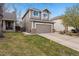 Charming two-story home with a well-maintained lawn, attached two-car garage, and lush green yard at 6774 St Vrain Ranch Blvd, Firestone, CO 80504