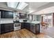 Charming kitchen featuring stainless steel appliances, wood floors, and access to an eat-in dining area at 6774 St Vrain Ranch Blvd, Firestone, CO 80504