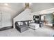Spacious living room featuring a large gray sectional couch, stairs to the second floor and open to the kitchen at 6774 St Vrain Ranch Blvd, Firestone, CO 80504