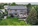 Aerial view of the backyard, showcasing lush landscaping, deck, patio, and well-maintained lawn at 6175 Puma Sands, Lone Tree, CO 80124