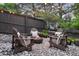 Backyard fire pit area with Adirondack chairs and pea gravel, perfect for entertaining outdoors at 6175 Puma Sands, Lone Tree, CO 80124