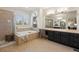 Spacious bathroom with a soaking tub, tiled shower, and dual vanities at 6175 Puma Sands, Lone Tree, CO 80124