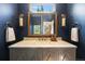 Powder room with a framed mirror and gold accents at 6175 Puma Sands, Lone Tree, CO 80124