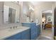 Charming bathroom features a double sink, white countertops, and modern blue vanity with stylish fixtures at 6175 Puma Sands, Lone Tree, CO 80124