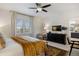 Primary bedroom featuring a ceiling fan, an ensuite bath, and plantation shutters at 6175 Puma Sands, Lone Tree, CO 80124