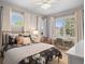 Bright bedroom with a plush bed, two windows, and a dedicated desk space at 6175 Puma Sands, Lone Tree, CO 80124