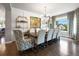 Elegant dining room with hardwood floors, modern lighting, large windows, and seating for eight at 6175 Puma Sands, Lone Tree, CO 80124